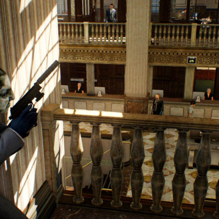 Payday 2 - A criminal in a suit takes cover in the upstairs of a large bank.